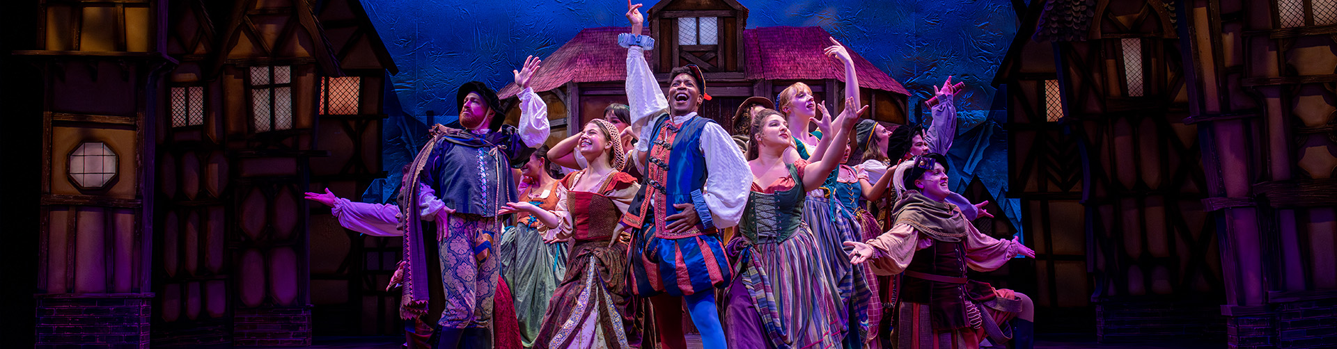 Something Rotten cast posed with hands in air