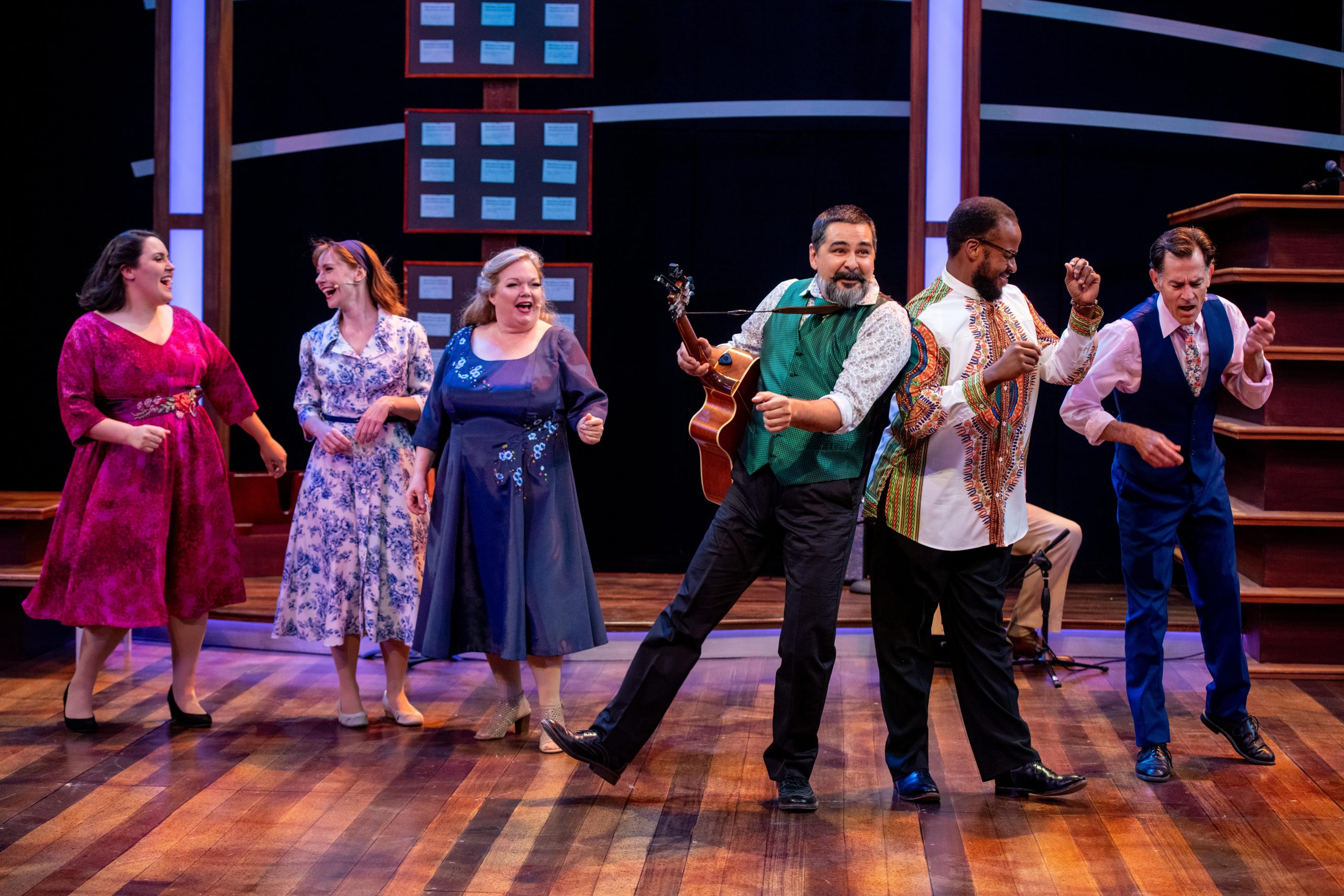 Actors on stage singing in Together, 2021