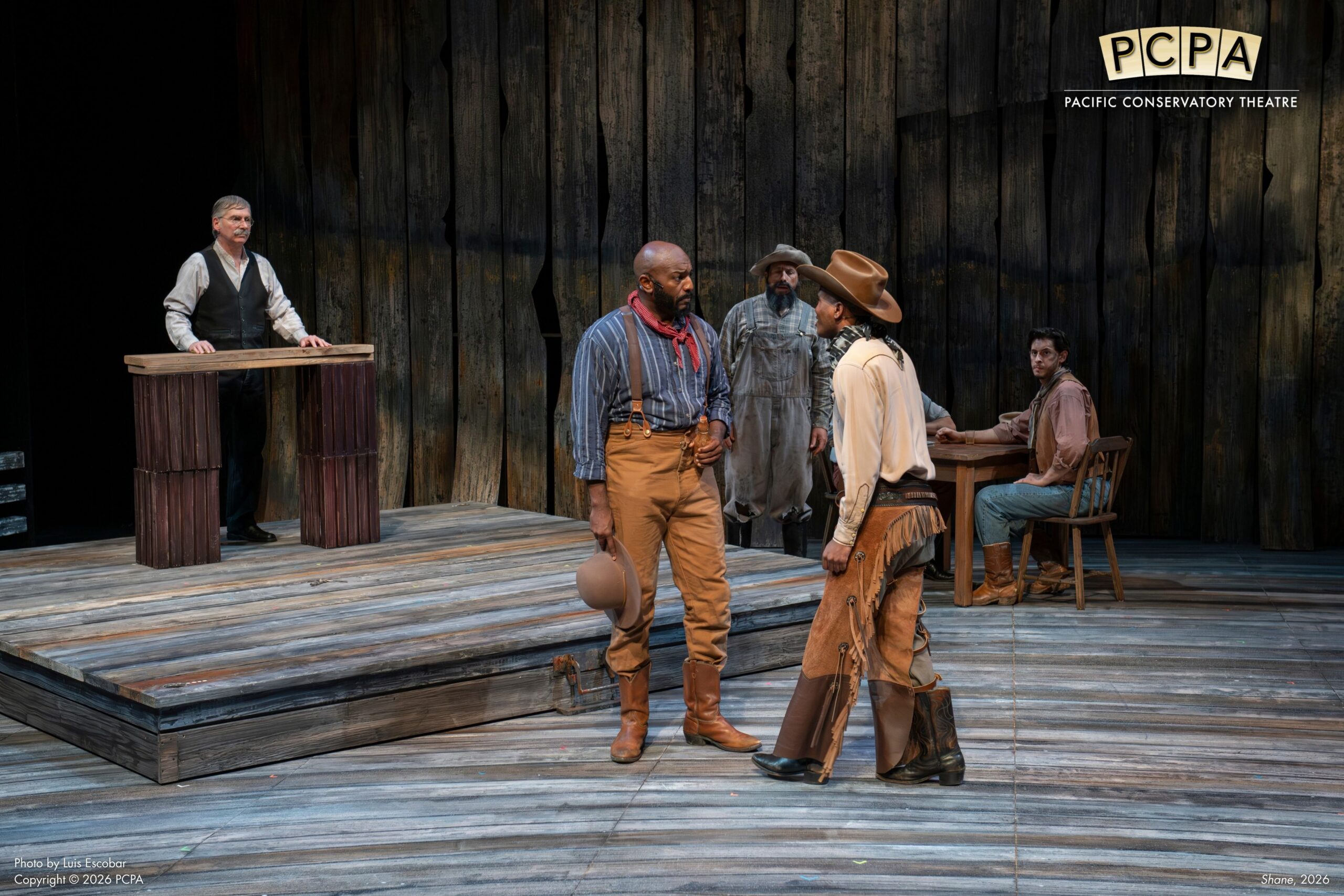 Actors on stage facing off